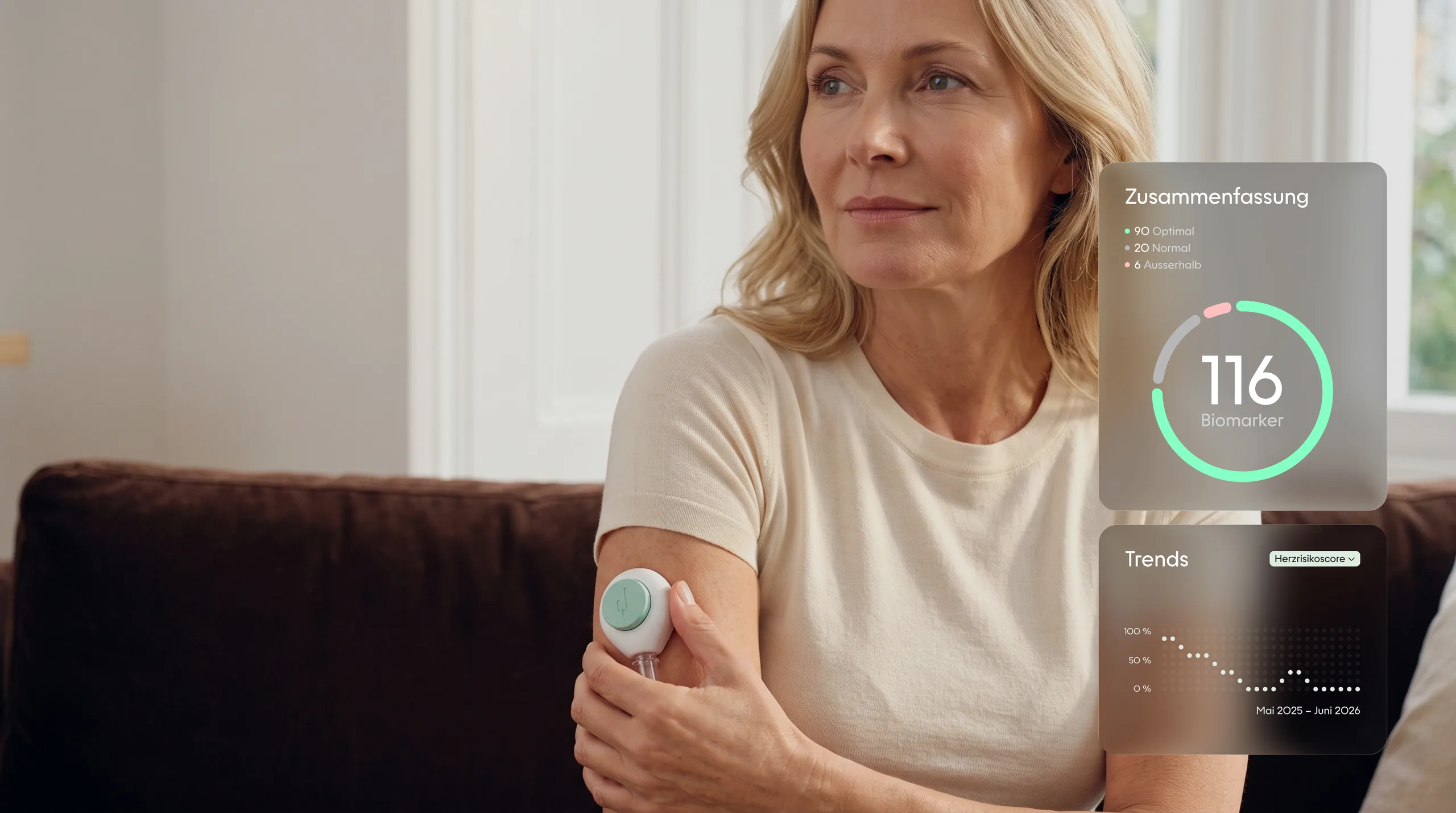 A woman at home on the sofa, the YEARS collection device on her upper arm, the summary of her values beside her