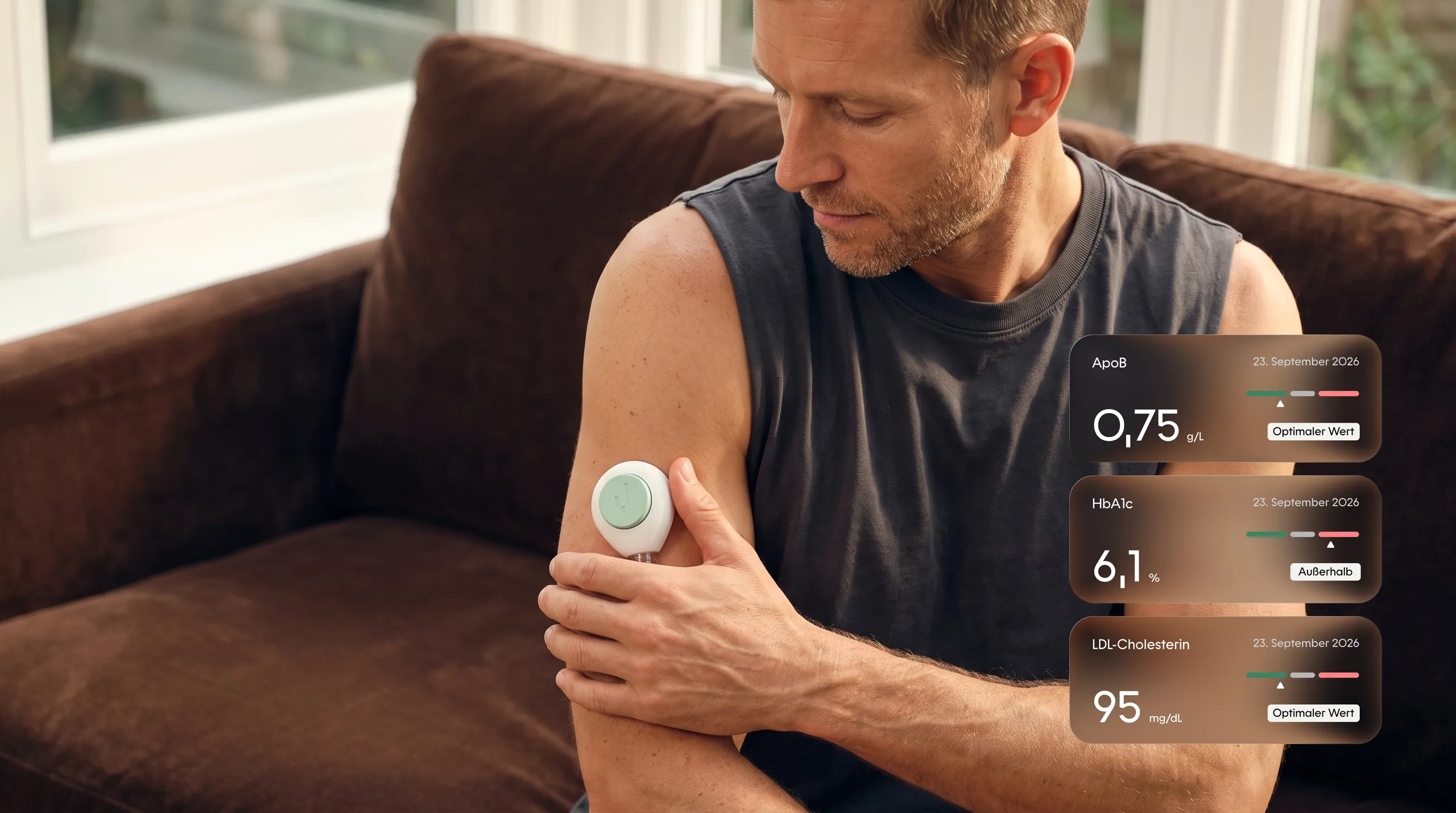 A man at home with the YEARS collection device on his upper arm, ApoB, HbA1c and LDL cholesterol beside him
