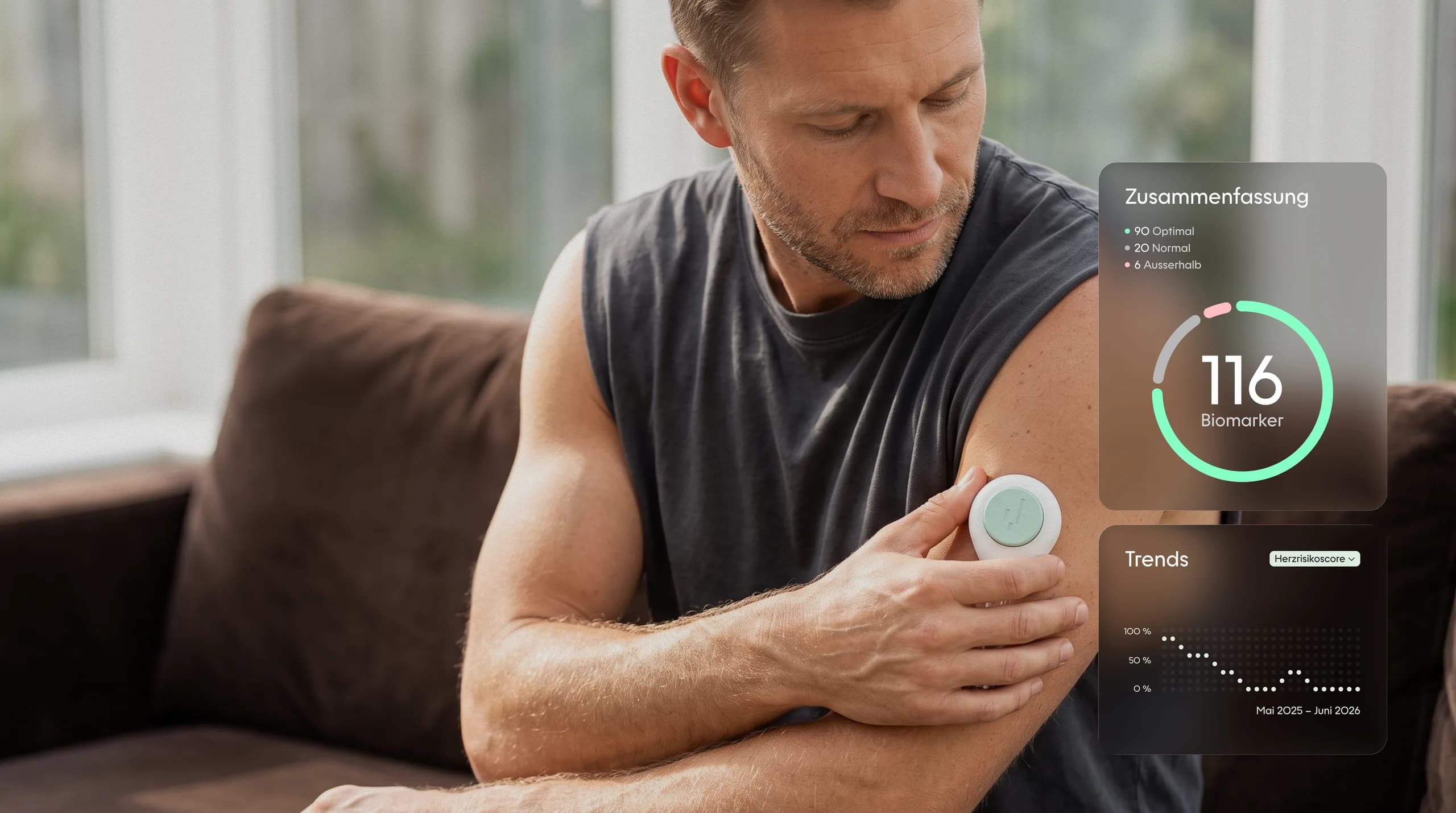 A man at home on the sofa, the YEARS collection device on his upper arm, the summary of his values beside him